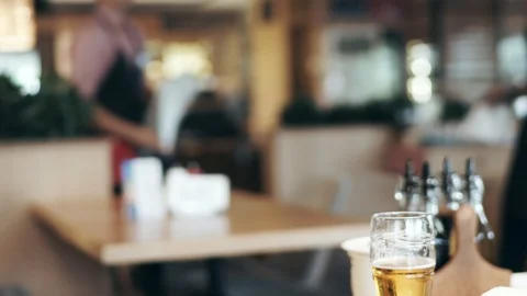 Blurred restaurant, waiters carry orders, wipe the table after visitors Stock Footage 100735020