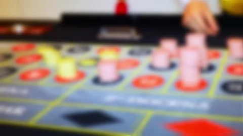 Blurred roulette table with colorful chips in casino Stock Footage 315895565