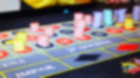 Blurred roulette table with dealer hand and colorful chips Video stock 315895596