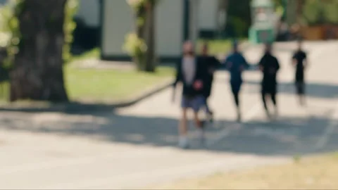 Blurred runners jogging together in a park Vídeo Stock 343044786