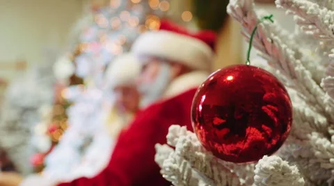Blurred santa and kid on lap, focusing on ornament Stock Footage 44756625