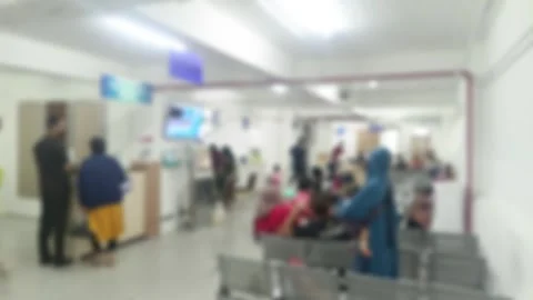 Blurred scene of diverse individuals in a waiting room, evoking the sense o.. Stock Footage 303831300