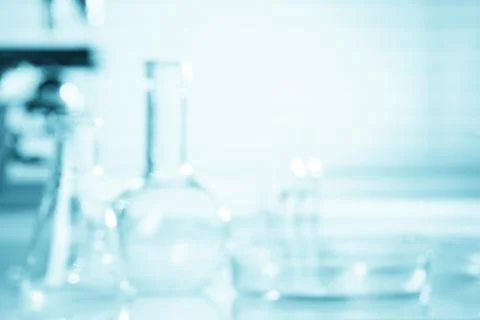 Blurred science background, test tubes and microscope with copy-space Foto stock
