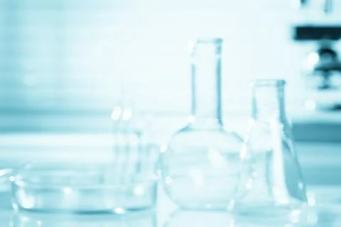 Blurred science background, test tubes and microscope, research concept Foto stock