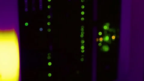 Blurred server rack with glowing green lights in a dark data center Stock Footage 340355925