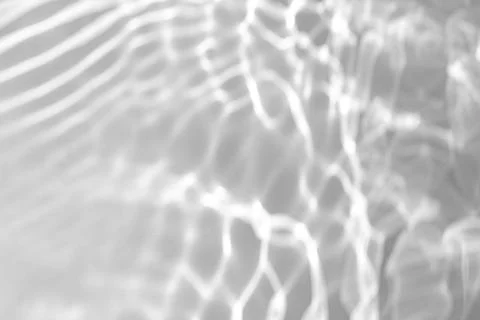 Blurred shadow and light caustic effect on a white wall Stock Photos