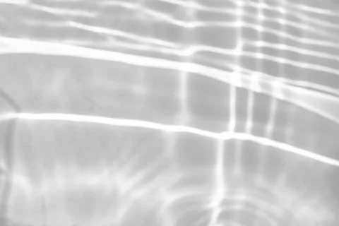 Blurred shadow and light caustic effect on a white wall Stock Photos