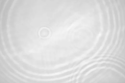 Blurred shadow and light caustic effect on a white wall Stock Photos