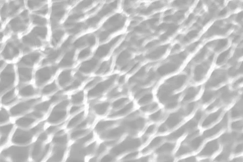 Blurred shadow and light caustic effect on a white wall Stock Photos
