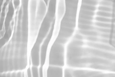 Blurred shadow and light caustic effect on a white wall Stock Photos