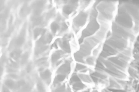 Blurred shadow and light caustic effect on a white wall Stock Photos