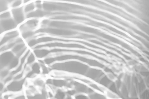 Blurred shadow and light caustic effect on a white wall Stock Photos