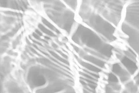 Blurred shadow and light caustic effect on a white wall Stock Photos