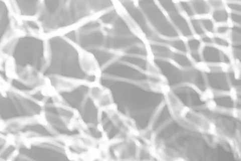 Blurred shadow and light caustic effect on a white wall Stock Photos