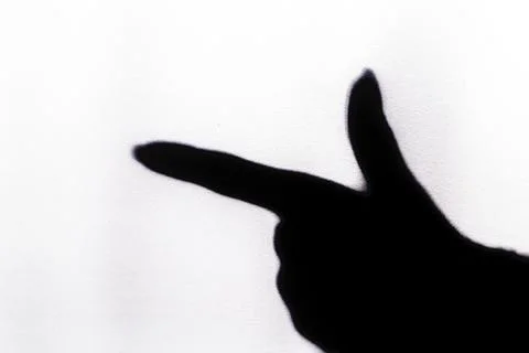 The blurred shadow of the index finger on the painted wall, the shadow of the Stock Photos
