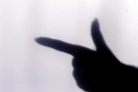 The blurred shadow of the index finger on the painted wall, the shadow of the Stock Photos