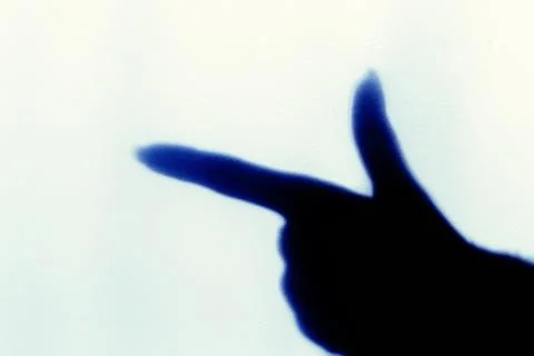 The blurred shadow of the index finger on the painted wall, the shadow of the Stock Photos