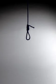 Blurred shadow of the loop of the gallows on the light wall, darkness, reduce Stock Photos