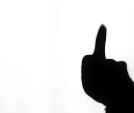 Blurred shadow of the middle finger on the painted wall, shadow of the middle Stock Photos