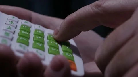 Blurred Shooting with a Man Calculating with an Adding Machine.  Stock Footage 238936561