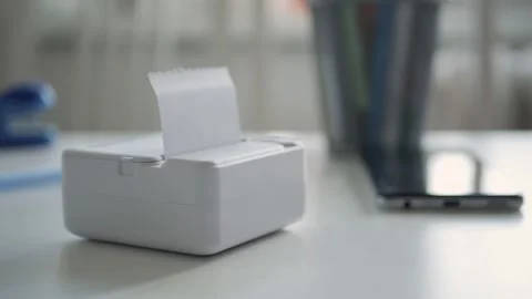 Blurred Shooting with a Mini Printer Printing a Document Using Internet. Stock Footage 285303033