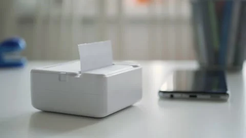 Blurred Shooting with a Mini Printer Printing a Document. Modern Technology Stock Footage 288027624