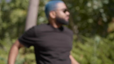 Blurred shot of a black man sunbathing suddenly looking at camera Stock Footage 287488740