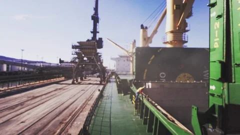 Blurred shot of bulk carrier unloading cargo in harbor Stock Footage 114509353