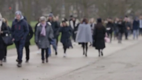 Blurred shot of daily commuters taking a short cut through a park Video stock 84636854