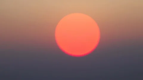 Blurred shot of a orange sunset sun coming in focus Stock Footage 121802014