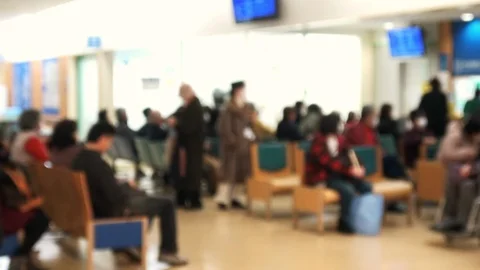 Blurred shot of people, patients in the waiting room at hospital. 4K Stock Footage