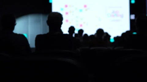 Blurred Silhouette Of Audience Watching Presentation At Business Tech Conference Stock Footage 338010177