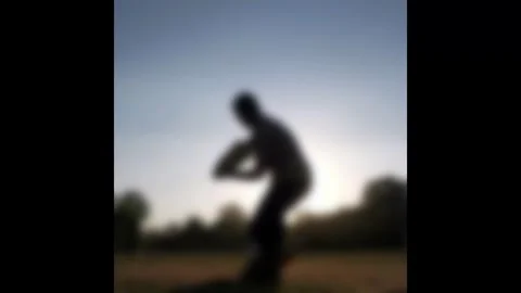 Blurred Silhouette of Cricket Batsman Playing a Shot During Golden Hour Sunset Stock Footage 322746317