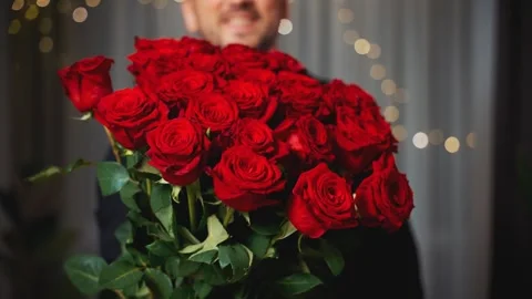 Blurred silhouette happy smiling face handsome man holding bouquet of red roses Stock Footage 311984177