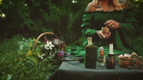 Blurred silhouette person sitting at table, green garden, boho gothic detail Stock Footage 337944032