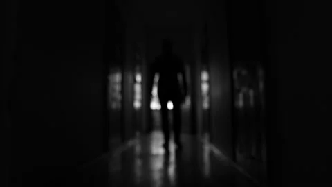 Blurred silhouette of an unknown man walking in the dark corridor. Stock Footage 149840831