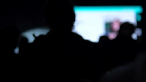 Blurred Silhouettes Of Audience Watching Presentation At Tech Conference Stock Footage 338010381