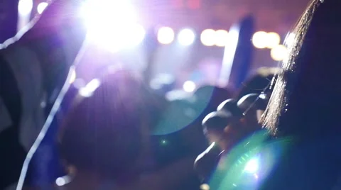Blurred silhouettes of concert crowd in front of bright stage lights in Asia Stock Footage 62644609