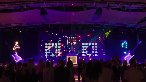 Blurred silhouettes of people dancing at a disco. Stock Footage 327773330