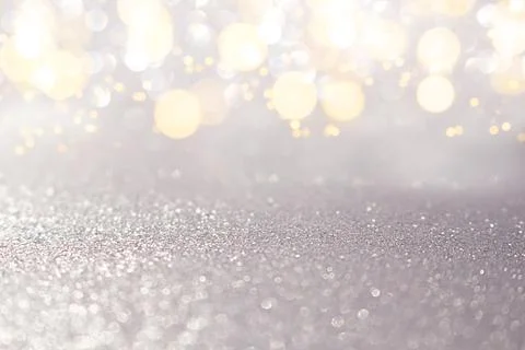 Blurred silver glitter background with sparkle. Christmas, New Year, March Stock Photos