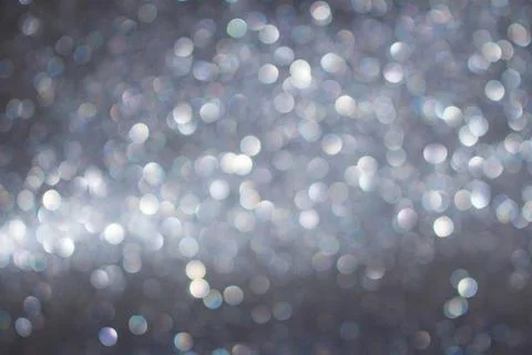 Blurred silver gray glitter background with glitter. Defocused circle light Stock Photos
