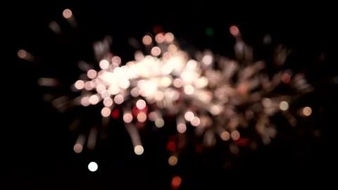 Blurred sky illuminated with bright multicolored fireworks flashes and bangs. Stock Footage 138262289