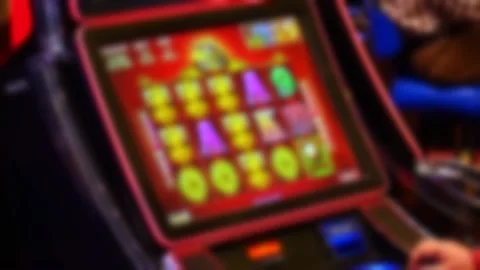 Blurred slot machine with red screen in casino Video stock 315895484