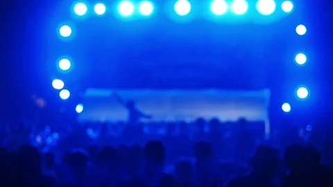 Blurred of some cheering fans dancing in a free live concert Stock Footage 93034601
