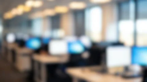 Blurred spacious open plan office interior featuring multiple computer moni.. Stock Photos