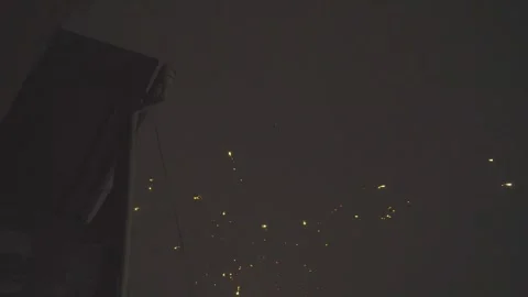 Blurred sparkler firework burning against a dark evening background creating a g Vídeo Stock 318242246