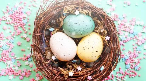 Blurred Spring Easter composition with colorful Easter eggs in nest. Stock Photos