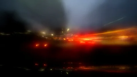 Blurred streaking lights illuminate stylized POV city night driving Stock Footage