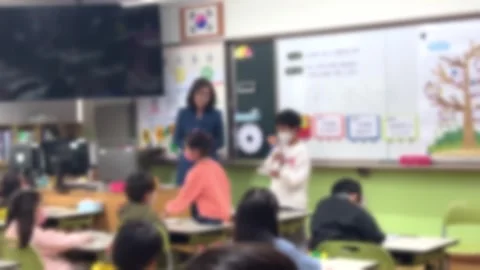 Blurred, students in elementary school classrooms with teachers Stock Footage 241709662
