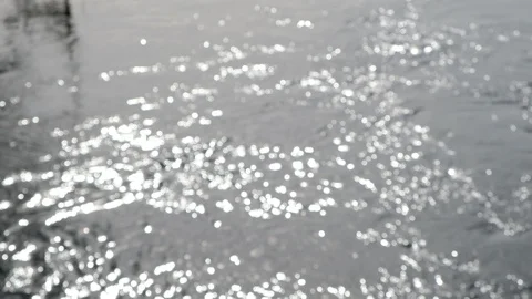 Blurred sun glare on the river or lake water. Rapid river flow. 스톡 동영상 128627311
